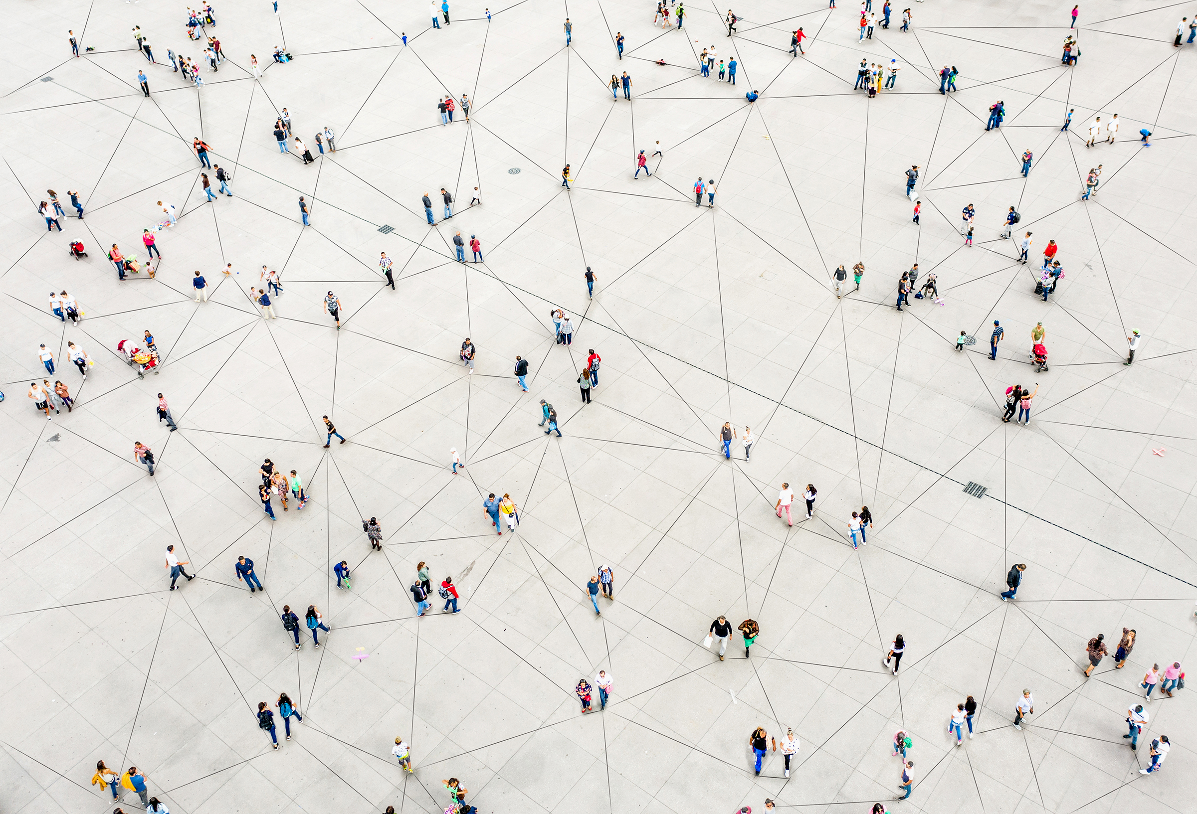 Aerial view of young people connected by a network of llines